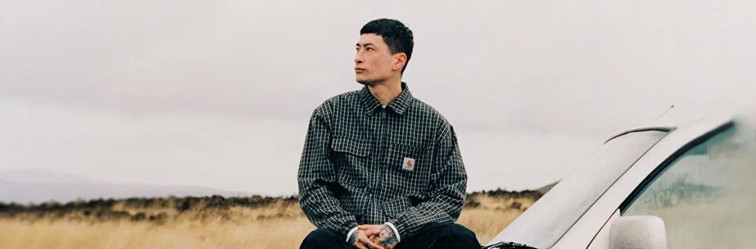 Man Sat on Car Wearing a Carhartt WIP Dryden Jacket