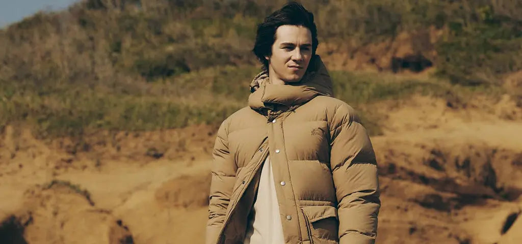 Man Standing Outdoors Wearing Gramicci First Down Jacket 