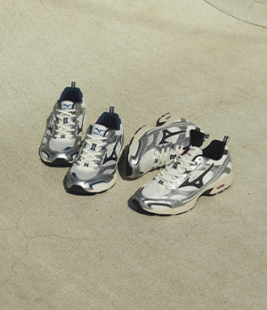 Two Pairs of Mizuno trainers on a neutral background, showcasing sleek design and performance-focused footwear.